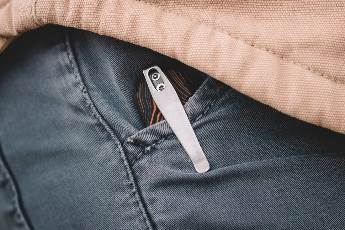 Minimalist folding city EDC knife held in hand